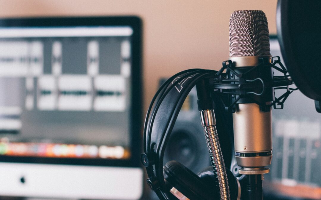 close up of a microphone with a blurred laptop screen in the background